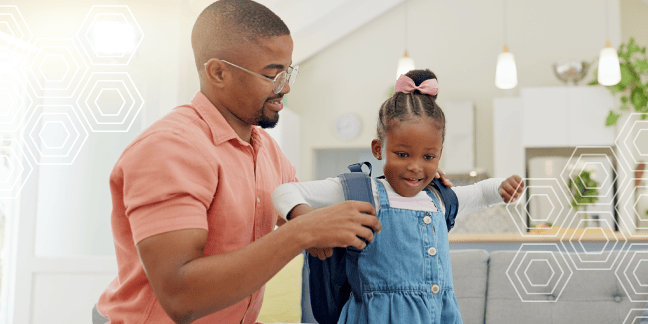 Adult man helping child get ready for school